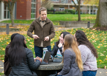 Professor of Psychology and Biology Baine Craft talks  with a few of his students from the first cohort of the Master of Science in Research Psychology program.